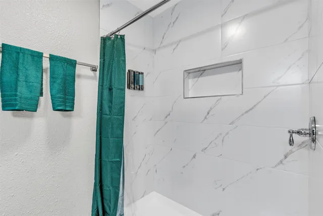 a bathroom with a bathtub and shower