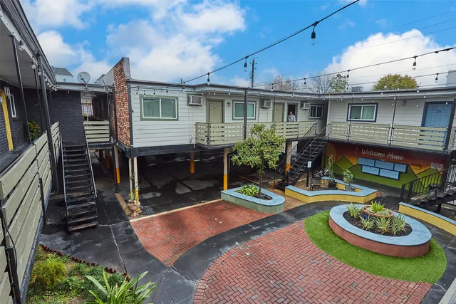 a front view of house with yard outdoor seating and outdoor kitchen