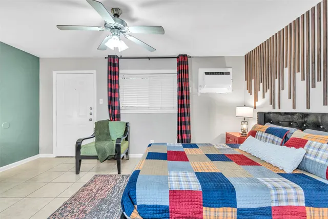 a bed sitting in a bedroom next to a window