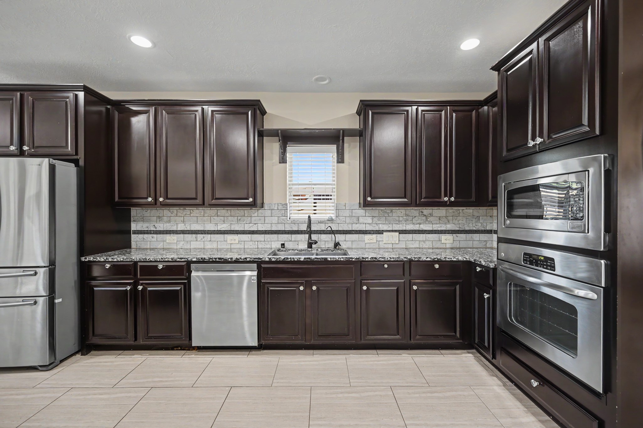 31325 Riley Woods Court Spring, TX 77386 - Photo 18 of 50 Plenty of room to cook and stay organized, with extensive cabinetry, counter space, stainless steel appliances including a built in oven and microwave.