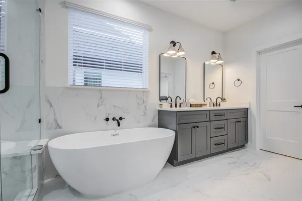 a bathroom with a tub sink and mirror