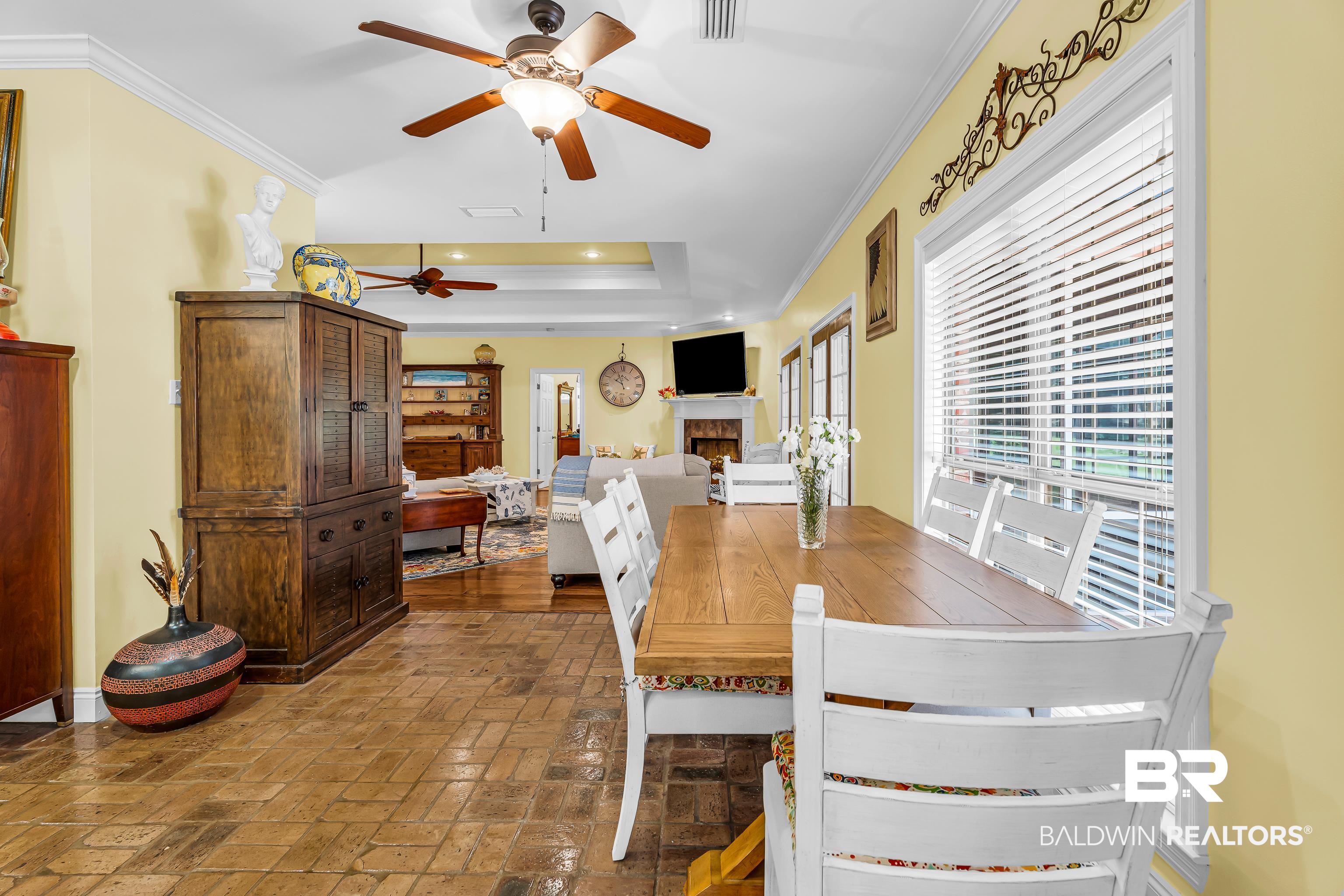 7014 Blakeley Road Daphne, AL 36527 - Photo 26 of 45 Open-concept living area featuring a vaulted ceiling with a ceiling fan, crown molding, and wood-finish flooring