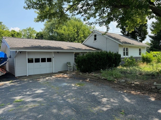 View of side of home with a garage