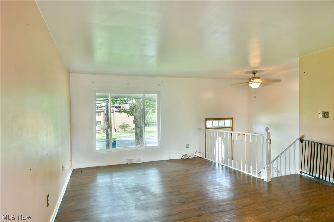 2470 North Road Southeast Warren, OH 44484 - Photo 15 of 35 Spare room featuring ceiling fan and dark hardwood / wood-style flooring