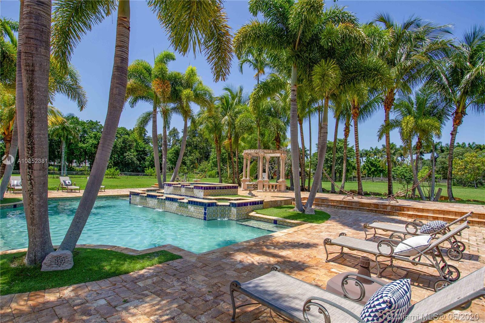 14201 Stirling Road Southwest Ranches, FL 33330 - Photo 52 of 61 Pool with stretch chairs