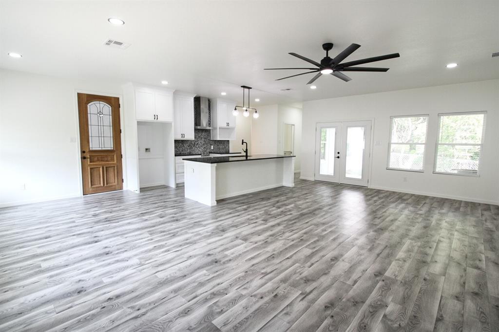 842 White Oak Drive Woodway, TX 76712 - Photo 11 of 12 a view of a kitchen with wooden floor and a window