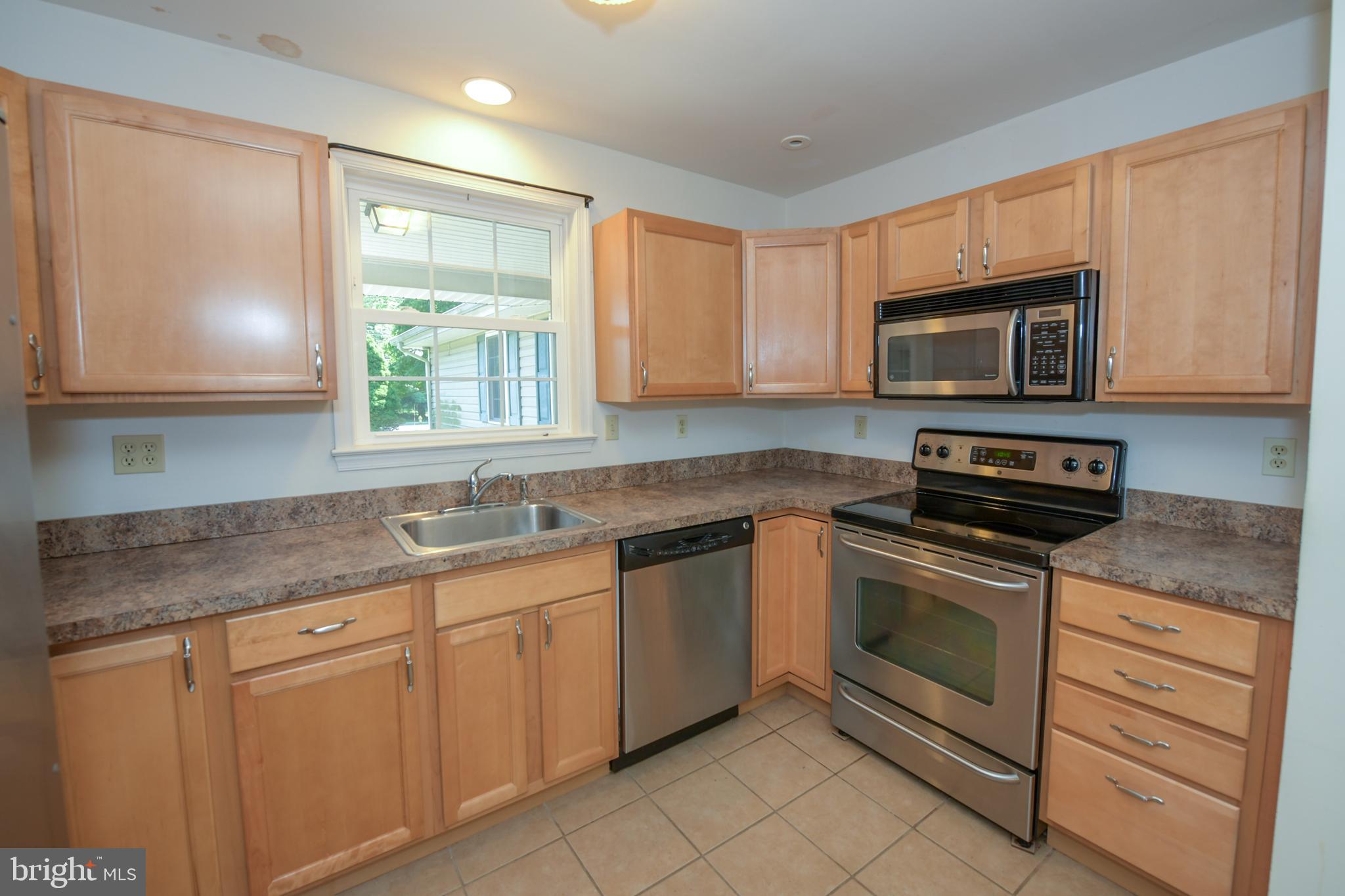 2 Broadale Road Doylestown, PA 18901 - Photo 26 of 56 a kitchen with stainless steel appliances granite countertop white cabinets granite counter tops and a window