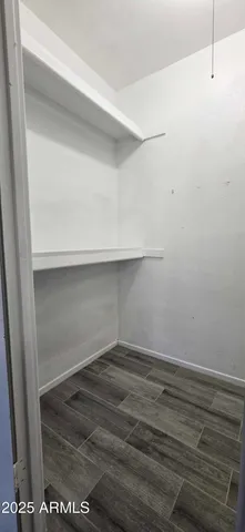 a view of storage and utility room with wooden floor