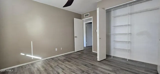 a view of an empty room with wooden floor