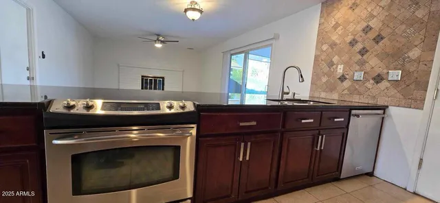 a kitchen with a stove and a sink