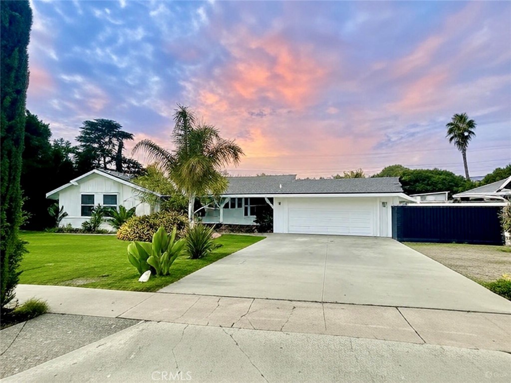 14191 Lambeth Way Tustin, CA 92780 - Photo 1 of 34 a front view of a house with a yard and a garage