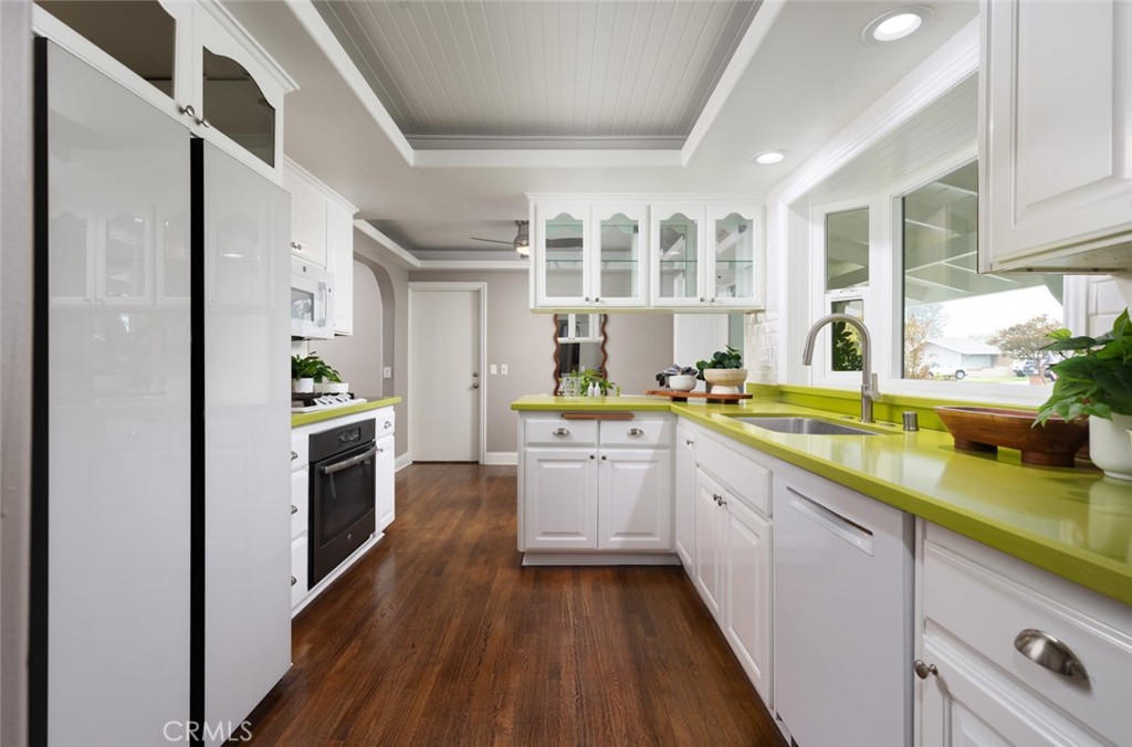 14191 Lambeth Way Tustin, CA 92780 - Photo 15 of 34 a kitchen with stainless steel appliances sink stove refrigerator and cabinets