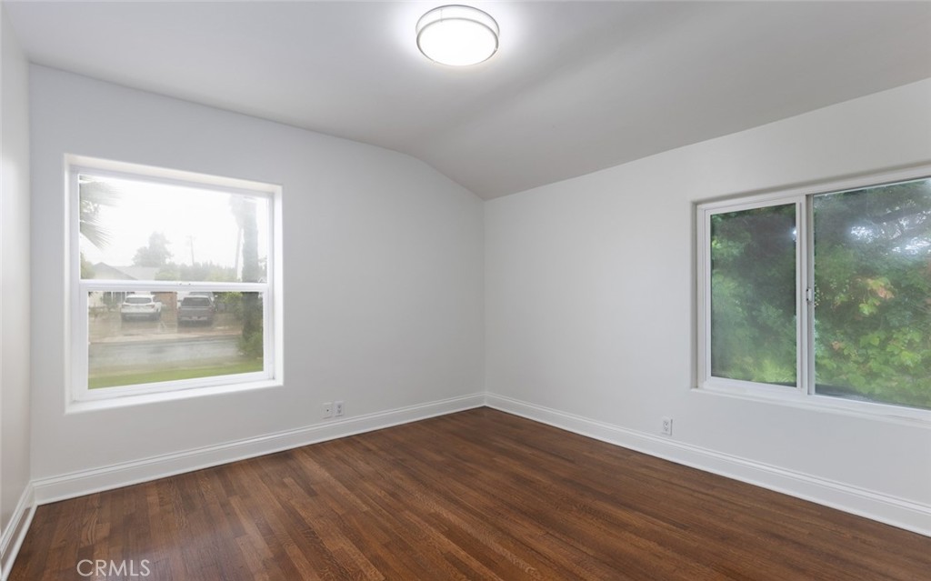 14191 Lambeth Way Tustin, CA 92780 - Photo 20 of 34 an empty room with wooden floor and windows