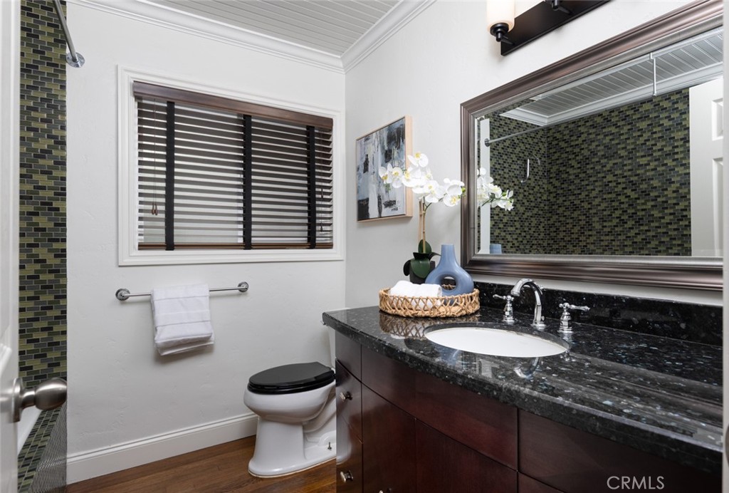 14191 Lambeth Way Tustin, CA 92780 - Photo 21 of 34 a bathroom with a granite countertop sink and a mirror