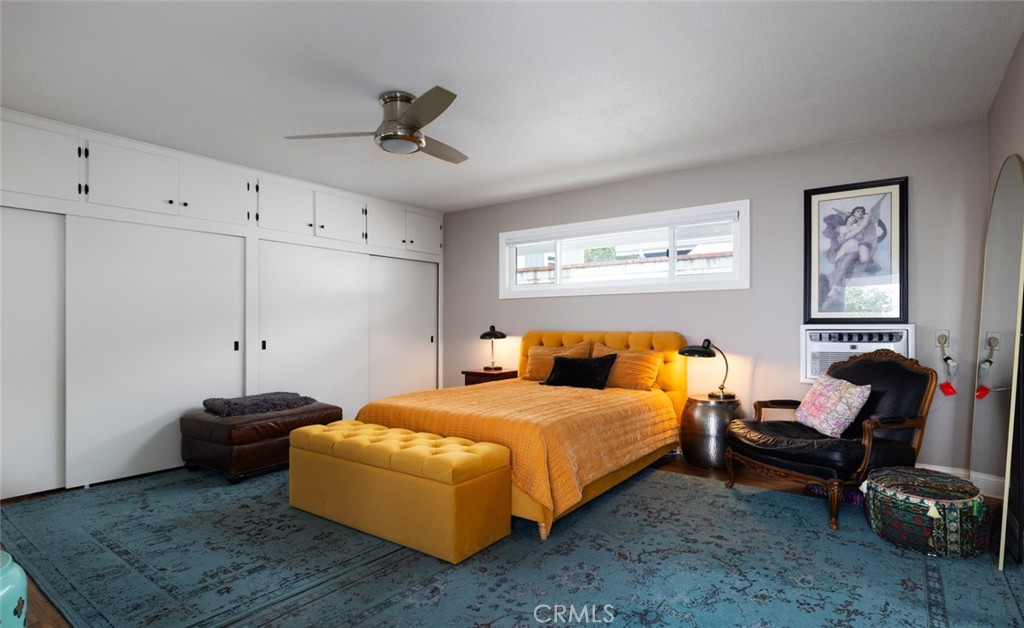 14191 Lambeth Way Tustin, CA 92780 - Photo 26 of 34 a bedroom with a bed and a chandelier