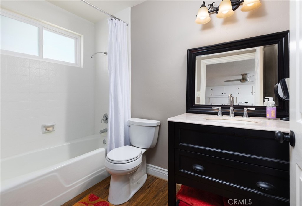 14191 Lambeth Way Tustin, CA 92780 - Photo 28 of 34 a bathroom with a sink a toilet a mirror and shower