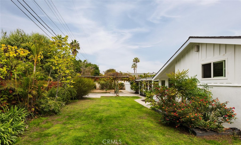 14191 Lambeth Way Tustin, CA 92780 - Photo 31 of 34 a yellow house with garden in front of it