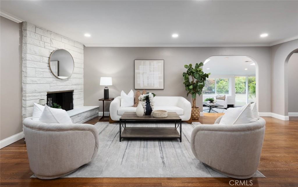 14191 Lambeth Way Tustin, CA 92780 - Photo 9 of 34 a living room with furniture wooden floor and a fireplace