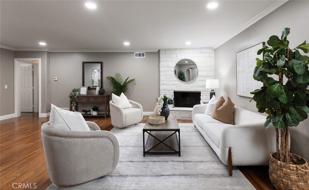 14191 Lambeth Way Tustin, CA 92780 - Photo 10 of 34 a living room with furniture fireplace and potted plant