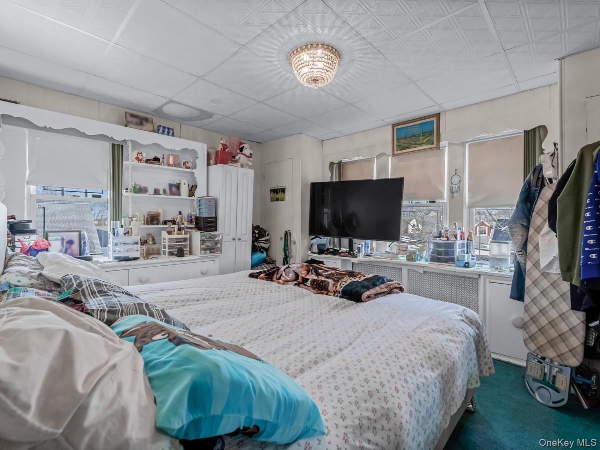 27-21 Coldspring Road Queens, NY 11691 - Photo 13 of 27 a bedroom with bed and a flat tv screen on dresser