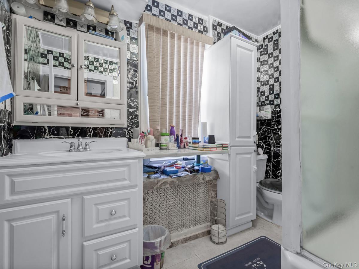 27-21 Coldspring Road Queens, NY 11691 - Photo 15 of 27 a bathroom with a granite countertop sink and a mirror
