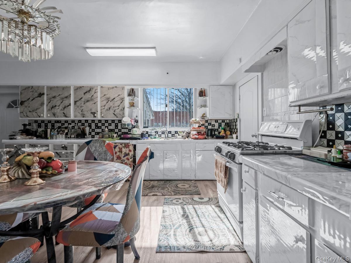 27-21 Coldspring Road Queens, NY 11691 - Photo 3 of 27 a kitchen with stainless steel appliances granite countertop a stove a sink dishwasher and cabinets