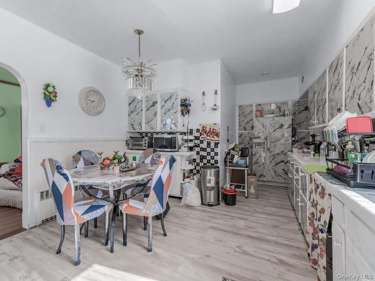 27-21 Coldspring Road Queens, NY 11691 - Photo 4 of 27 a view of a dining room with furniture and chandelier