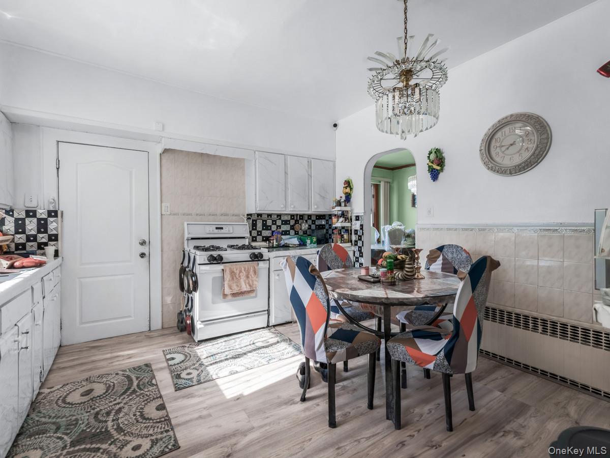 27-21 Coldspring Road Queens, NY 11691 - Photo 5 of 27 a kitchen with a dining table and chairs