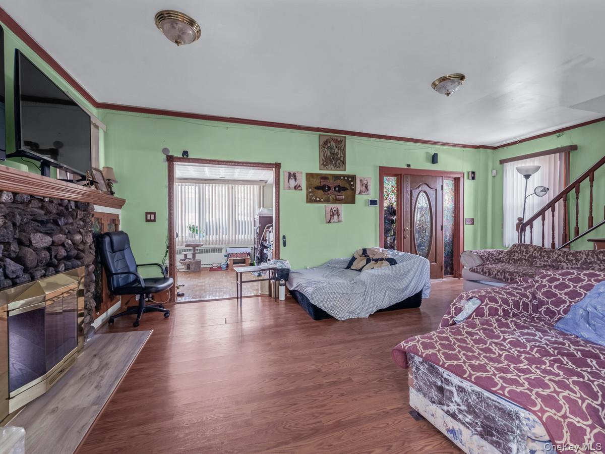 27-21 Coldspring Road Queens, NY 11691 - Photo 6 of 27 a living room with furniture and a flat screen tv