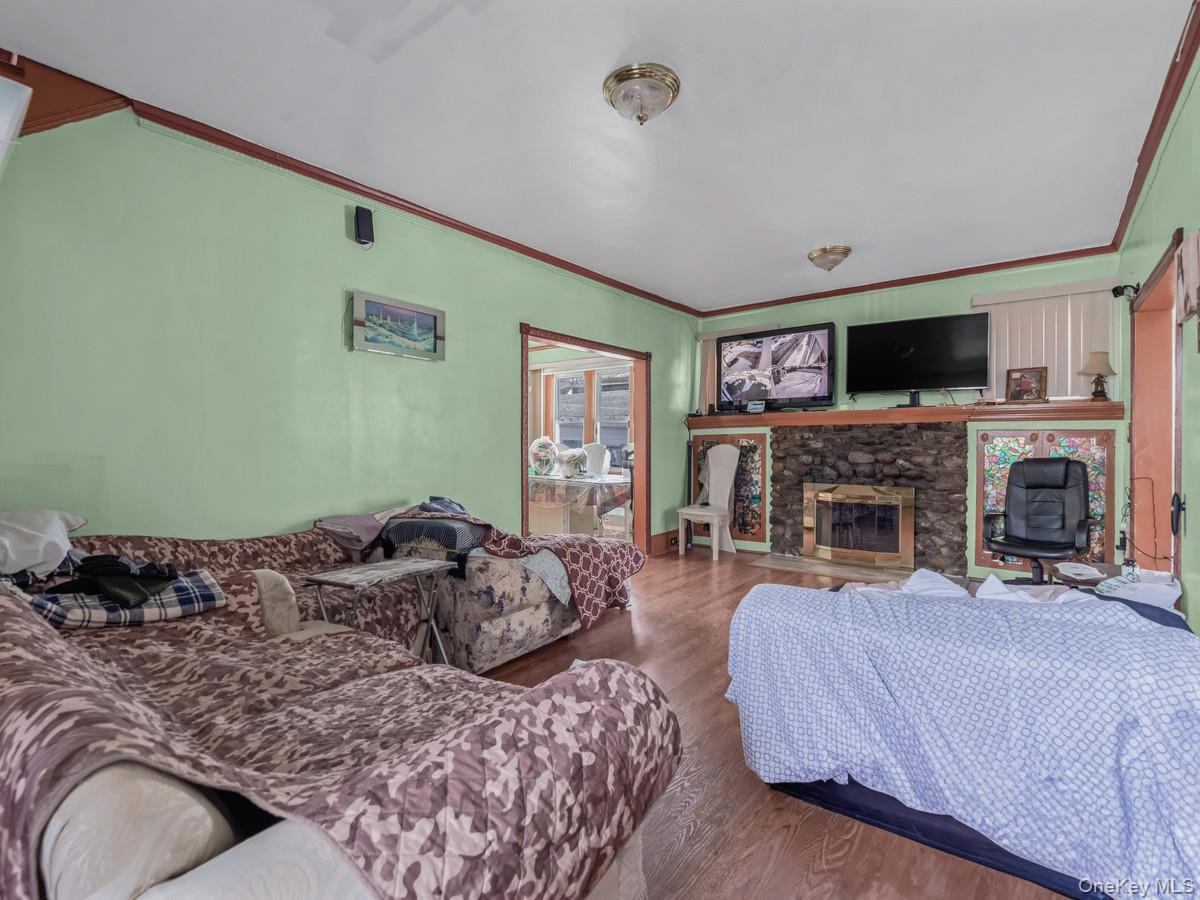 27-21 Coldspring Road Queens, NY 11691 - Photo 7 of 27 a bedroom with a bed and a flat screen tv