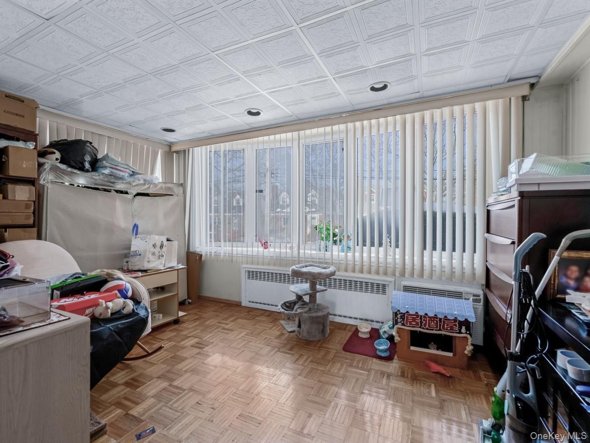 27-21 Coldspring Road Queens, NY 11691 - Photo 8 of 27 a bedroom with furniture and a wooden floor