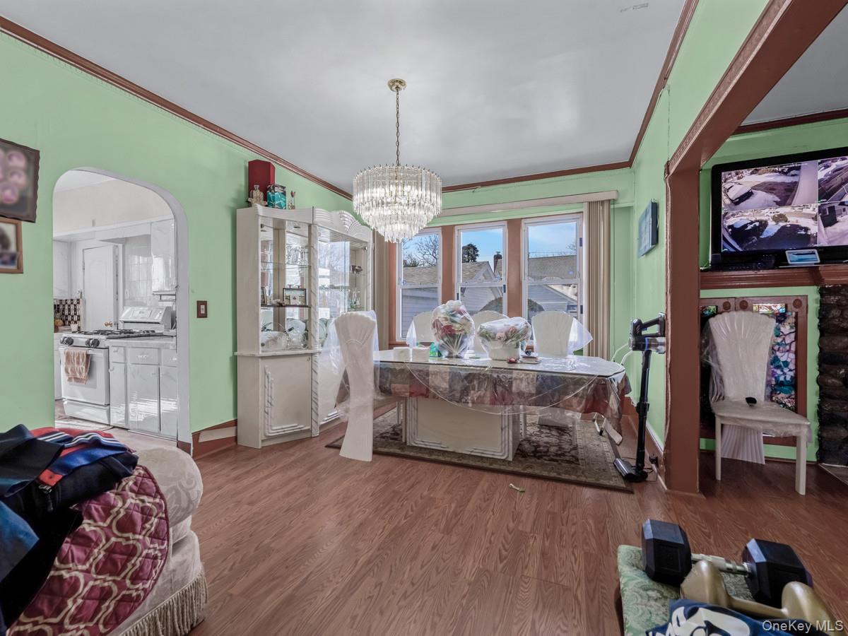 27-21 Coldspring Road Queens, NY 11691 - Photo 9 of 27 a living room with furniture and a chandelier