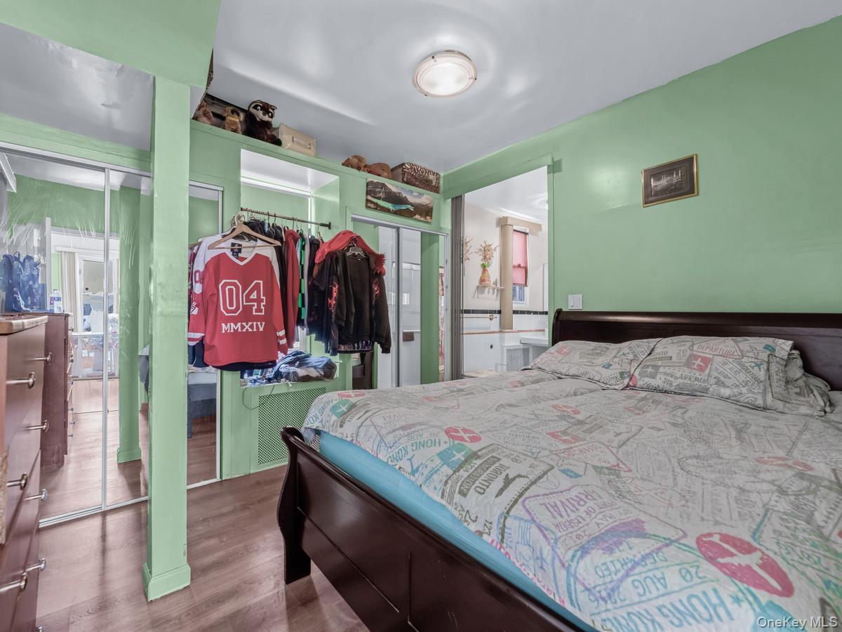 27-21 Coldspring Road Queens, NY 11691 - Photo 10 of 27 a bedroom with a bed and a walk in closet