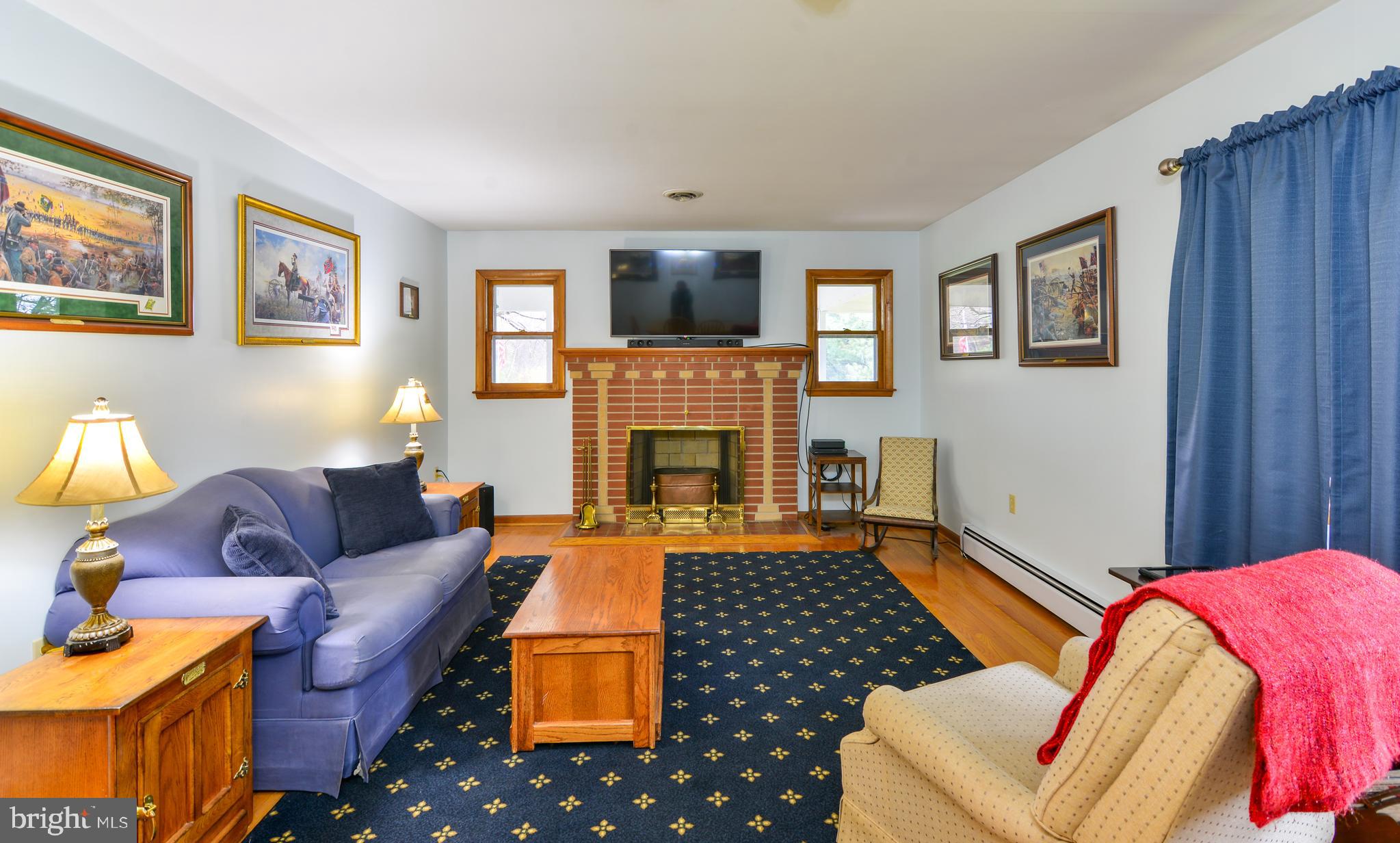 6914 North Clifton Road Frederick, MD 21702 - Photo 17 of 50 Wood burning fireplace in living room