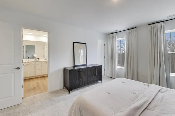 a bedroom with a bed and mirror