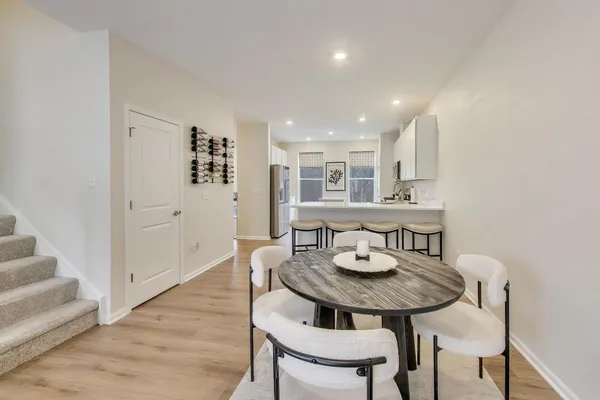 a view of a dining room with furniture and wooden floor