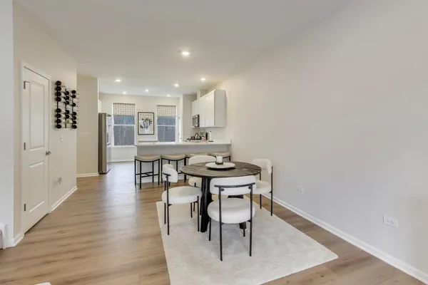 a view of a dining room with furniture and wooden floor