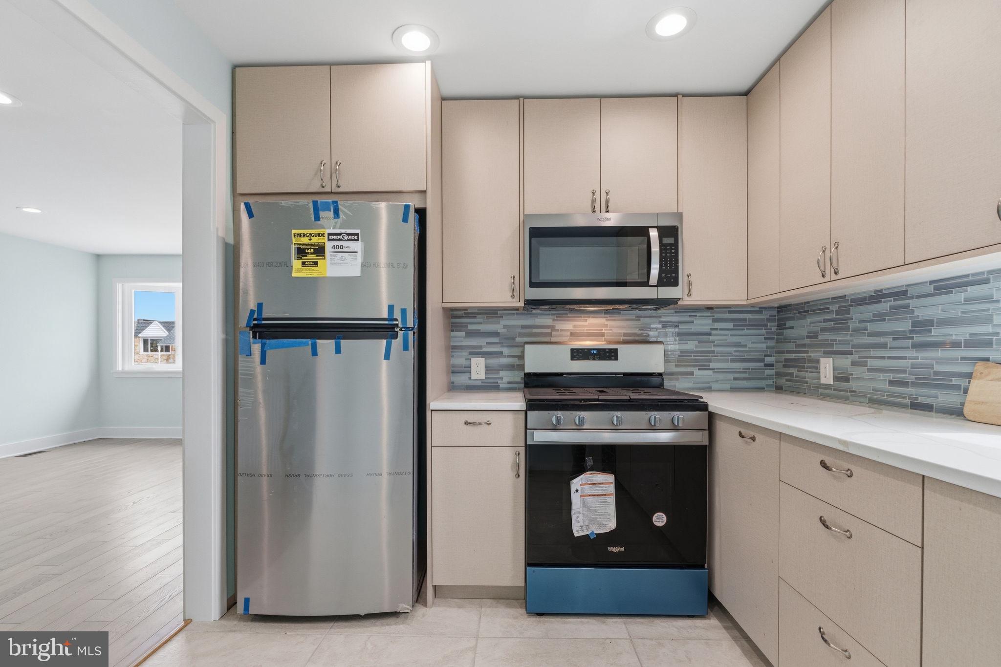 1944 Morrell Street Philadelphia, PA 19115 - Photo 16 of 44 a kitchen with stainless steel appliances granite countertop a stove a refrigerator and a microwave