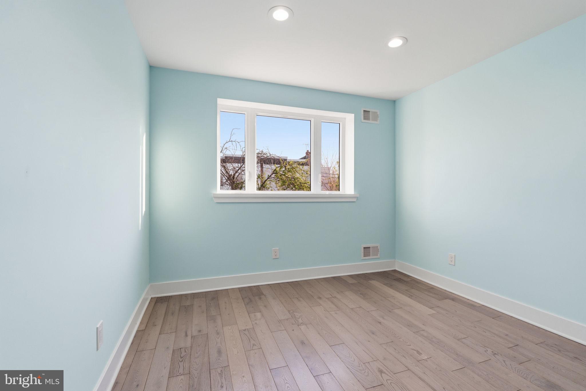 1944 Morrell Street Philadelphia, PA 19115 - Photo 22 of 44 an empty room with wooden floor and windows