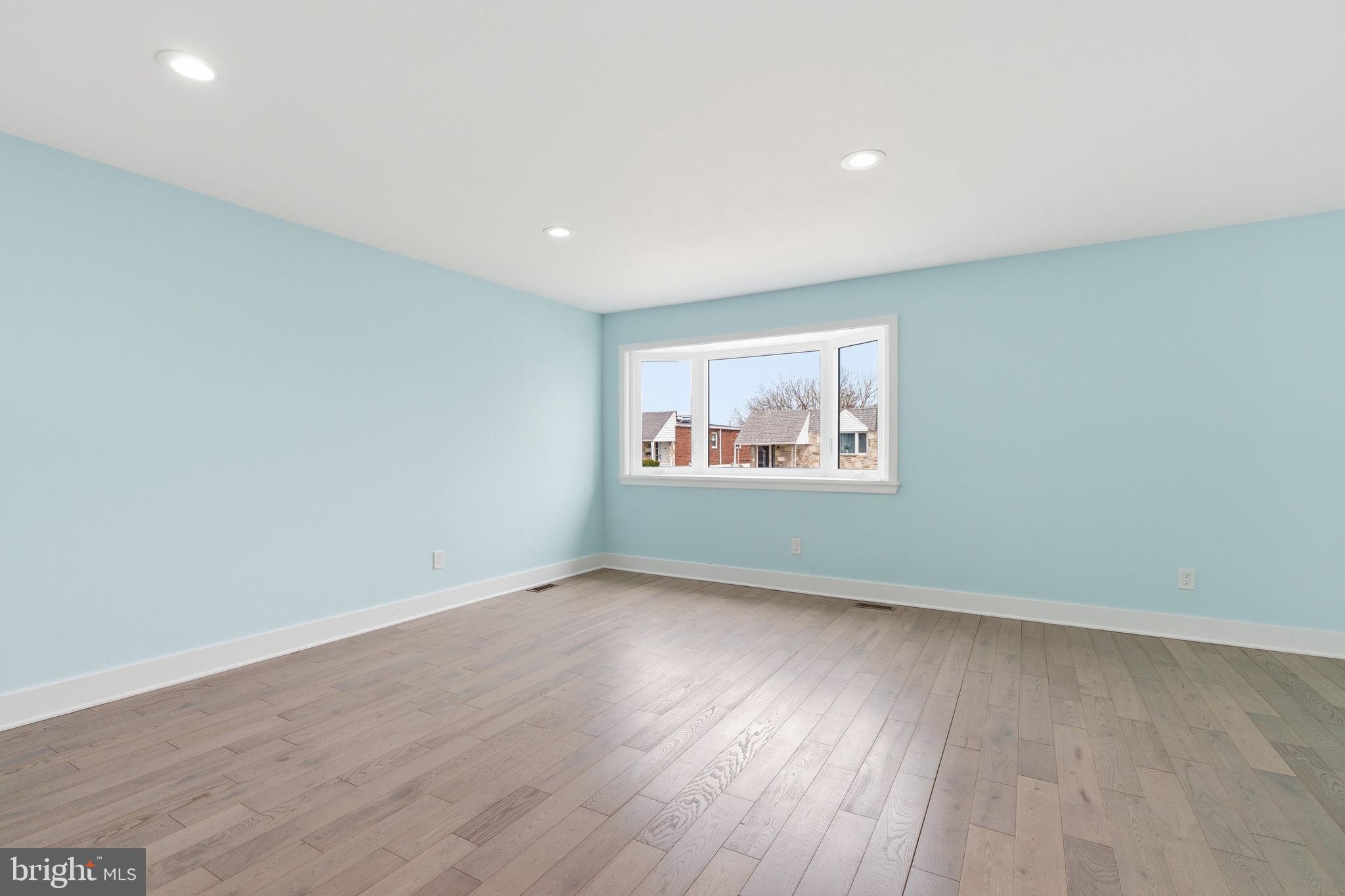 1944 Morrell Street Philadelphia, PA 19115 - Photo 10 of 44 a view of an empty room with wooden floor and a window