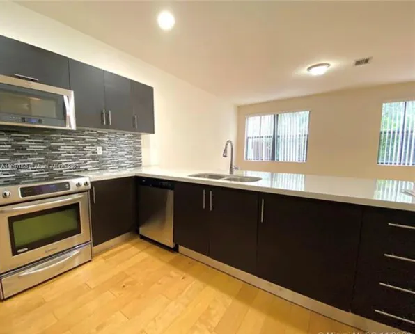 a kitchen with a sink and a oven