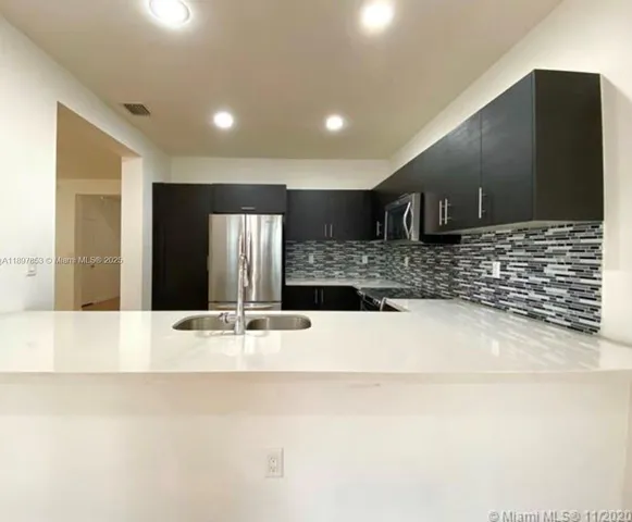 a view of counter top space with stainless steel appliances