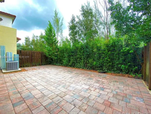 a sidewalk with a trees