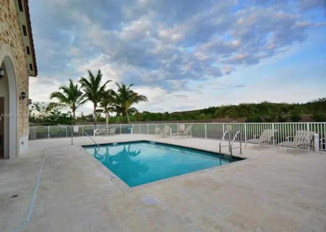 a view of a swimming pool with a yard