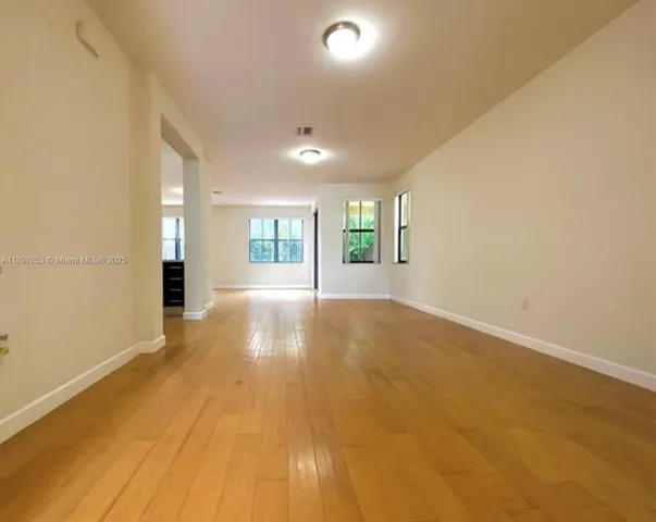 an empty room with windows and entrance