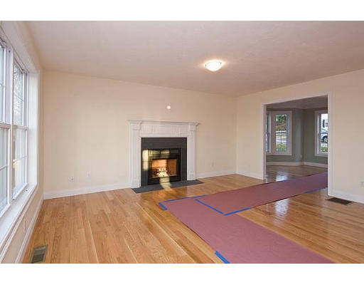 183 Florence Road Waltham, MA 02453 - Photo 5 of 18 a view of empty room with wooden floor and fireplace