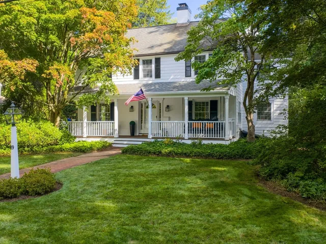 a front view of a house with a garden and plants