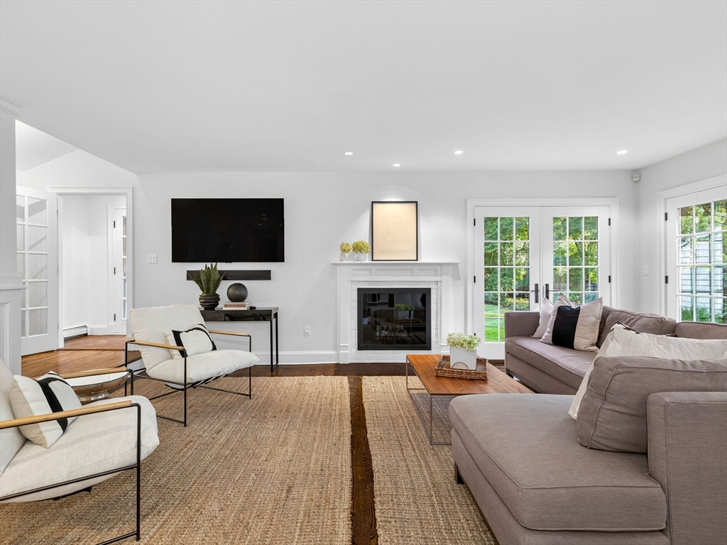 19 Marvin Road Wellesley, MA 02482 - Photo 11 of 33 a living room with furniture a fireplace and a flat screen tv