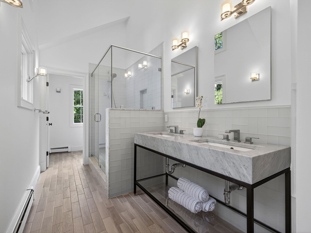 19 Marvin Road Wellesley, MA 02482 - Photo 21 of 33 a bathroom with a sink a toilet a mirror and shower