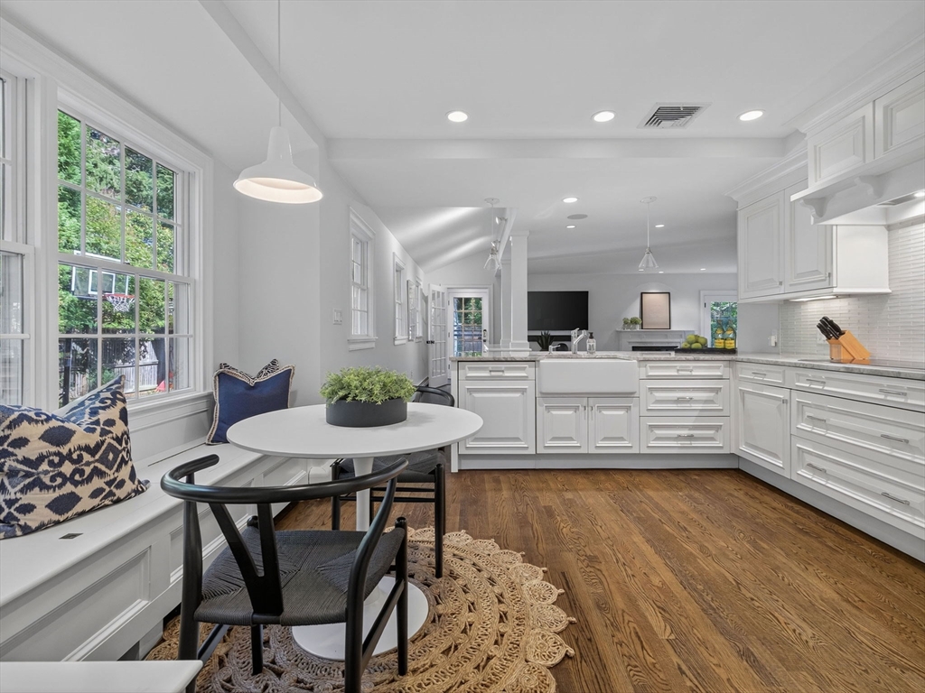 19 Marvin Road Wellesley, MA 02482 - Photo 4 of 33 a kitchen with stainless steel appliances kitchen island granite countertop a stove a sink and a dining table